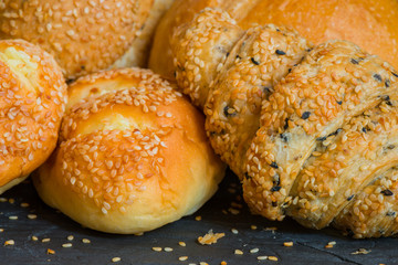 Traditional homemade bakery bread with sesame, Stack of fresh bread on stone table