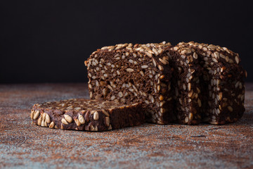 Fresh black bread with sunflower seeds on an old rusty table. With copy space