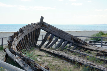 Fototapeta na wymiar Old broken boat on sea coast in Santa Pola, Alicante, Spain