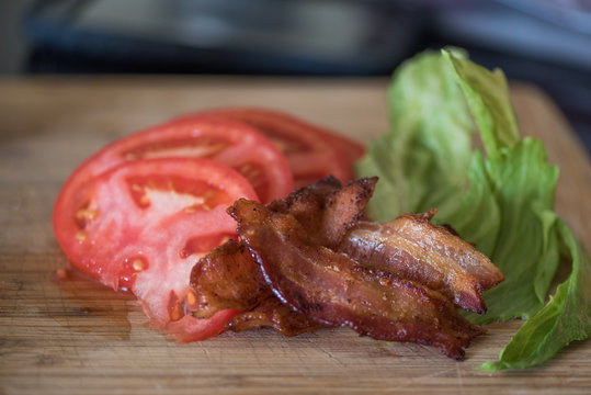 Bacon, lettuce and tomato prepared on a cutting board