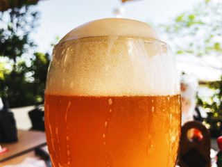 A glass of beer close up on a street cafe background