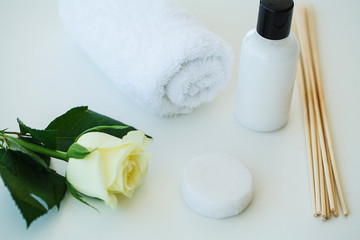 Fototapeta na wymiar Spa still life with blossoms of white rose and essential oils.