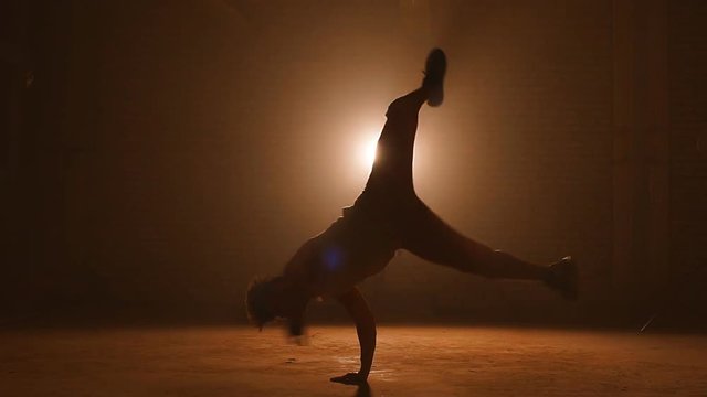 Young stuntman performing the trick in the air. Making complex movements. Air spinning.