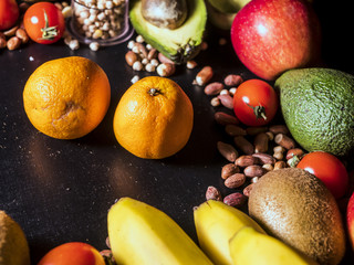 fresh organic natural diet fruits vegetables and seed with grain on black dark surface