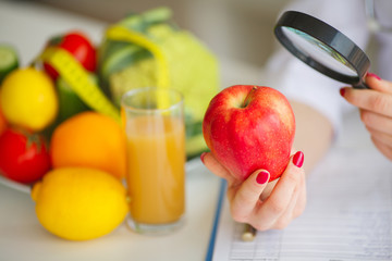 Conceptual Photo Of A Female Nutritionist With Fruits On The Desk