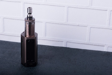 Electronic Cigarette in front of Brick Wall.Vaping Mod.