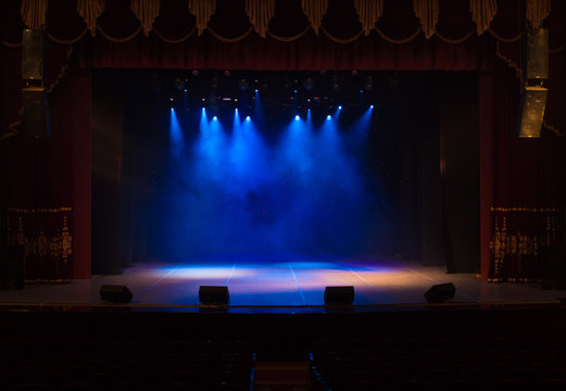 An Empty Stage Of The Theater, Lit By Spotlights And Smoke Before The Performance