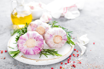 Garlic. Fresh garlic, oil and rosemary on kitchen table