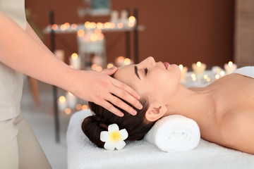 Obraz na płótnie Canvas Young woman receiving massage in spa salon