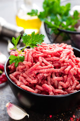 Raw ground beef meat with ingredients for cooking. Fresh minced meat