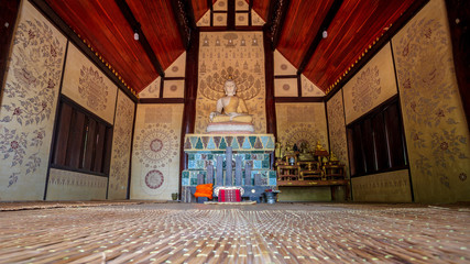 Fototapeta na wymiar Wat Pa Or Romyen, The temple in Chianrai, beautiful drawing, Sculpture and ceramic tiles in the chapel are made by famous artists of Thailand with the floor made by bamboo