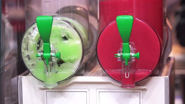 Colourful, cool, refreshing ice king slushy refreshment machine close up view