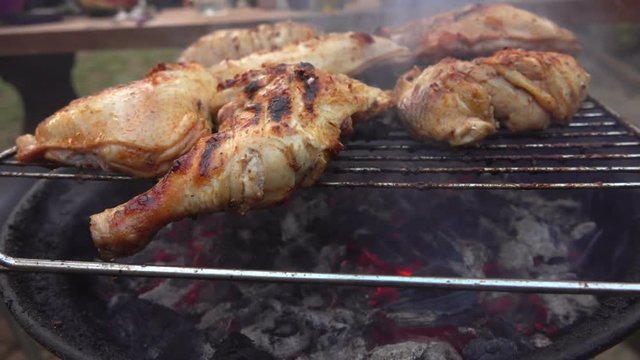 Chicken legs roasted on a grill outdoors