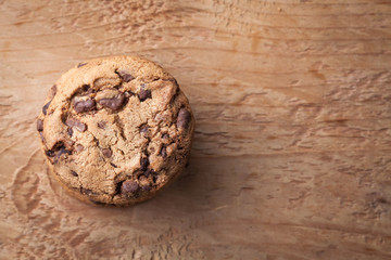 Cookies with chocolate chips on a wooden table. Top view with copy space
