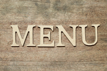 English alphabet in word menu on wood background