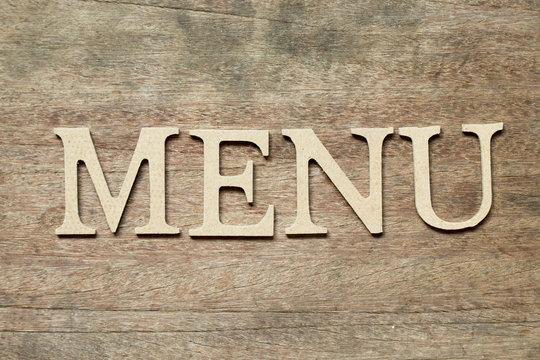 English alphabet in word menu on wood background