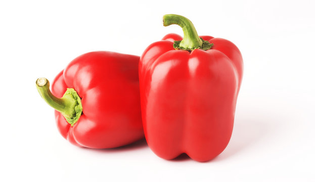 Two red Bell peppers isolated on white background. Minimal healthy food concept.