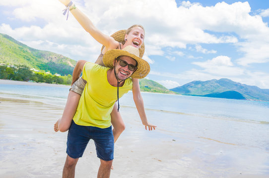 Portrait of a couple of lovers having fun at a tropical island on holiday.