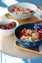 Oatmeal Breakfast with strawberry slices and banana slices, all sprinkled with bran