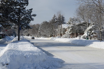 Heavy winter snow fall in a Canadian city street in residential area covered in snow