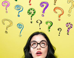 Question Marks with young woman on a yellow background