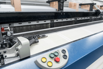 weaving loom at a textile factory, closeup. industrial fabric production line