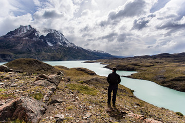 man looking toward awesome view of Torres del Paine mountain range