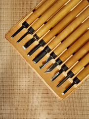 Tools for wood carving on a textured board