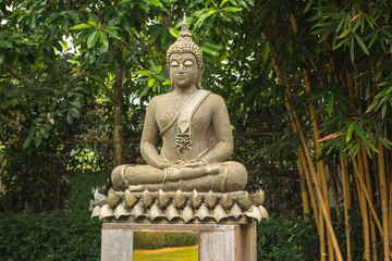 Artificial Buddha is in the garden. In the midst of the shady and cool in beautiful nature.