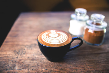 Cup of hot latte coffee on wooden table
