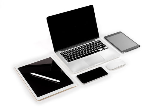 Office Table With Laptop Computer, Digital Tablet, Smartphone, Pencil And Mouse On Isolated Pure White Background / Laptop And Tablet Mockup Concept. (Selective Focus)