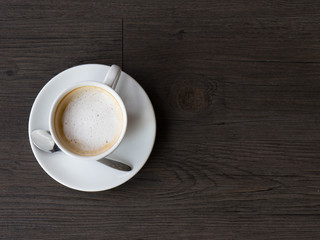 Closeup latte art of coffee white cup on wooden table surface