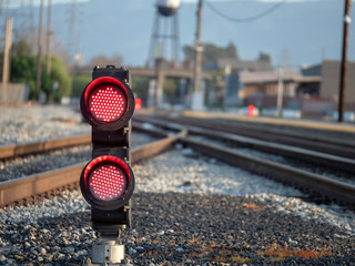 Red flashing lights on ground level at the railroad