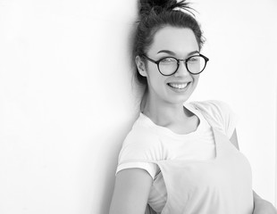 Fototapeta premium Portrait of young beautiful brunette woman girl model with nude makeup in colorful summer pink hipster clothes posing near wall. Going crazy and looking happily in camera