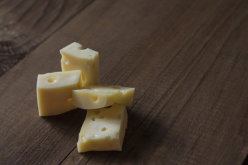 a few pieces of hard cheese on the board