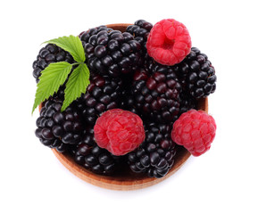 blackberries with raspberries in wooden bowl isolated on white background top view