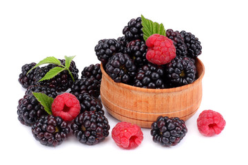 blackberries with raspberries in wooden bowl isolated on white background