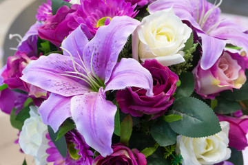 Rose and lilies fake flower and Floral background. rose and lilies flowers made of fabric. The fabric flowers bouquet. Colorful of decoration artificial flower