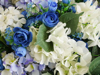 Obraz premium Rose fake flower and Floral background. rose flowers made of fabric. The fabric flowers bouquet. Colorful of decoration artificial flower