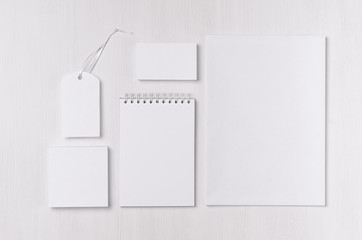 Corporate identity set of blank white stationery on soft white wood board. Template for branding,...