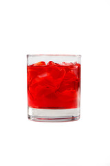 A single-colored transparent cocktail, refreshing in a low glass with ice cubes and taste of berries, cherries, strawberries, greiprut. Side view. Isolated white background. Drink for the menu