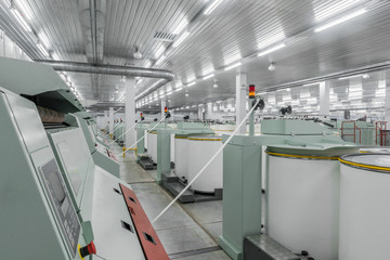 Machinery and equipment in the workshop for the production of thread, overview. interior of industrial textile factory
