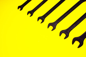 black wrench tool set on yellow background