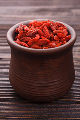 dried goji berries on a wooden rustic background