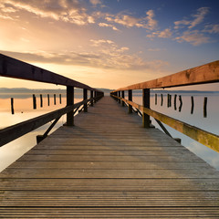 Lake with Long Wooden Pier at Sunrise