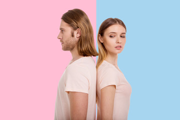 Curious creature. Beautiful young woman peeking into her boyfriends direction while standing...