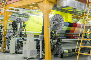 Machine and equipment in the weaving shop. interior of industrial textile factory