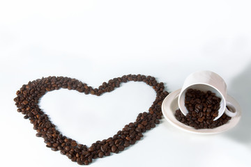 Coffee cup and coffee beans in the form of a heart