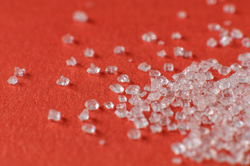 macro shot of sugar crystals scattered over an orange surface