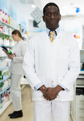 Naklejka na ściany i meble male pharmacist standing in pharmacy